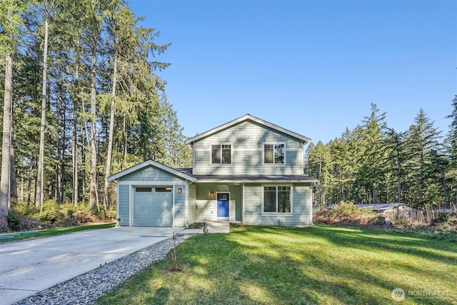 view of front of home with an attached garage, driveway, and a front yard