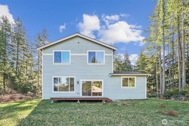 rear view of house with a yard