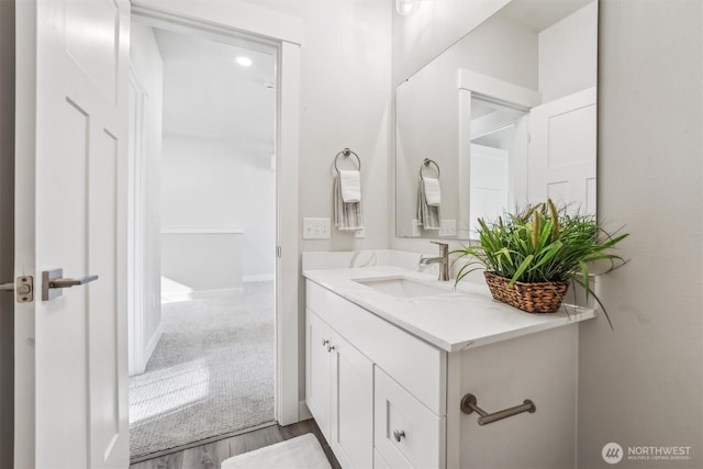 bathroom with vanity and wood finished floors