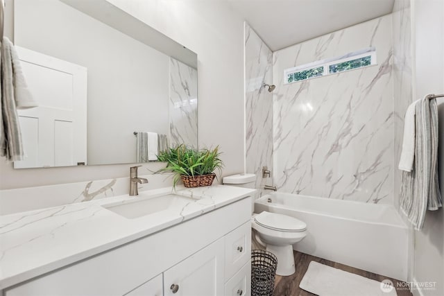 full bathroom featuring toilet, shower / bathing tub combination, wood finished floors, and vanity