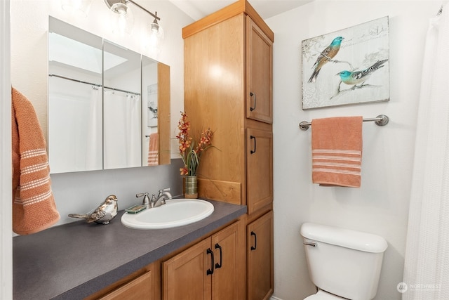 bathroom featuring vanity and toilet