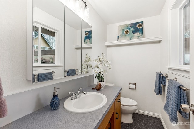 bathroom featuring vanity and toilet