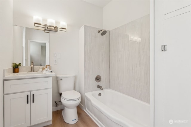 full bathroom with vanity, tiled shower / bath combo, toilet, and hardwood / wood-style flooring