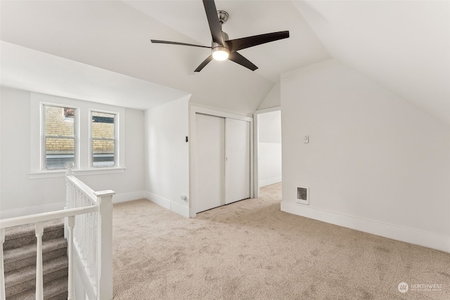 bonus room with light carpet, vaulted ceiling, and ceiling fan