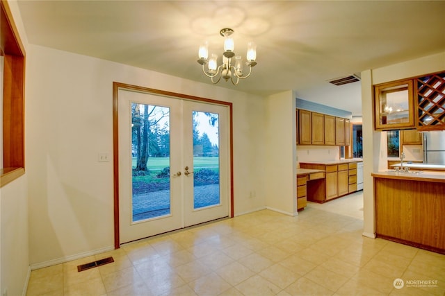 doorway featuring sink, french doors, and a chandelier