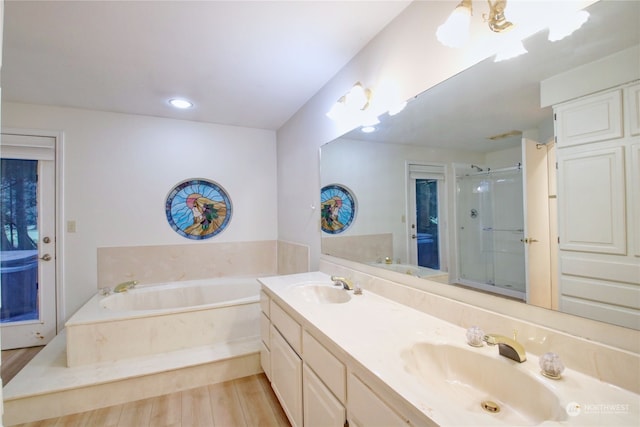 bathroom with vanity, separate shower and tub, and hardwood / wood-style floors