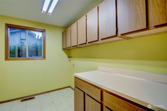 laundry room featuring cabinets