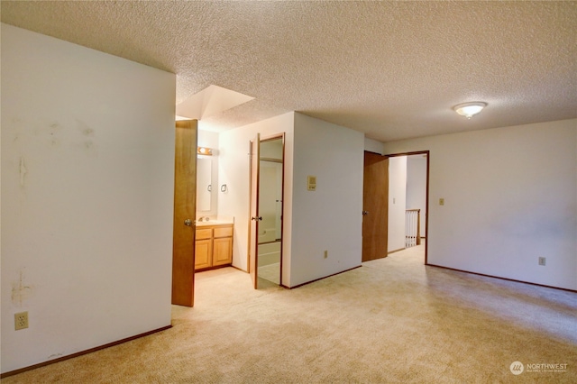 carpeted spare room featuring radiator and a textured ceiling