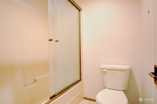 bathroom with shower / bath combination with glass door and toilet