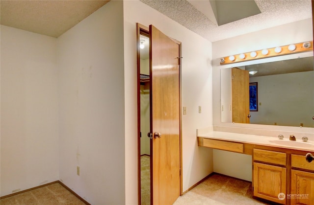 bathroom with vanity and a textured ceiling