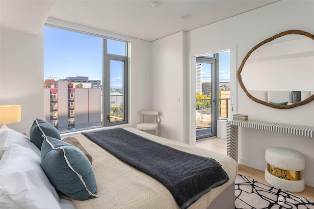 bedroom featuring access to outside and light hardwood / wood-style floors