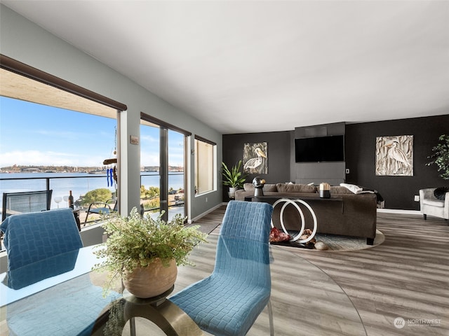 dining area with a water view and hardwood / wood-style flooring