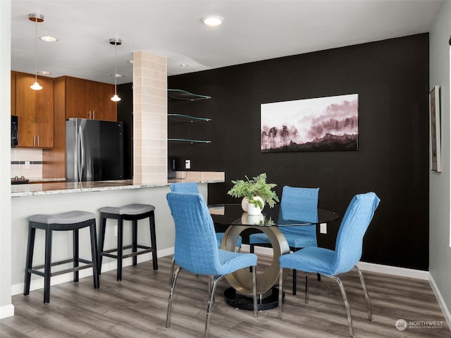 dining area with hardwood / wood-style floors