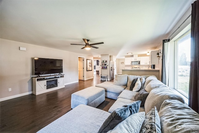 living room with dark hardwood / wood-style floors and ceiling fan