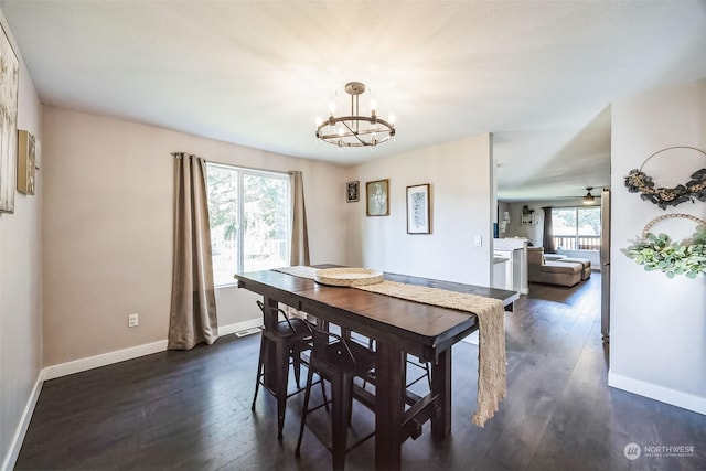 dining room featuring a notable chandelier and dark hardwood / wood-style flooring