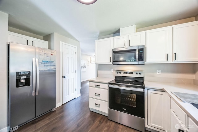 kitchen with appliances with stainless steel finishes, dark hardwood / wood-style floors, and white cabinets