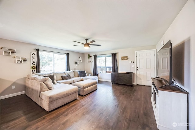 living room featuring dark hardwood / wood-style flooring and ceiling fan