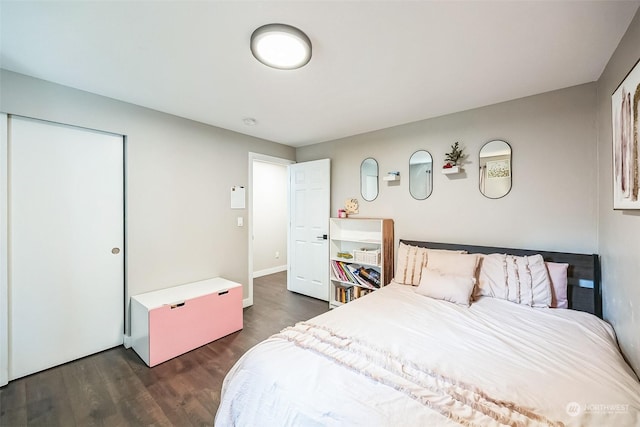 bedroom with dark hardwood / wood-style floors