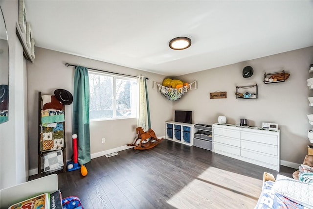 recreation room with dark hardwood / wood-style flooring