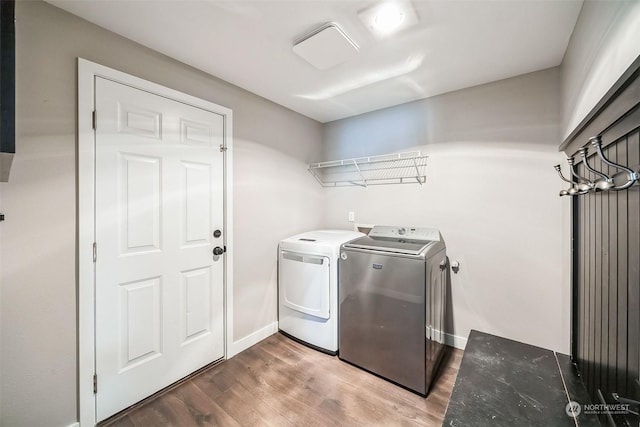 laundry room featuring wood-type flooring and independent washer and dryer