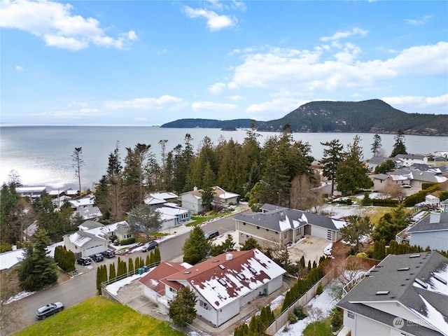 birds eye view of property featuring a water and mountain view