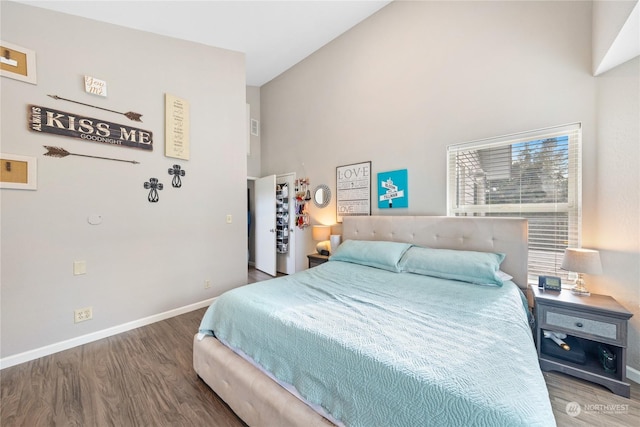 bedroom featuring hardwood / wood-style floors and high vaulted ceiling