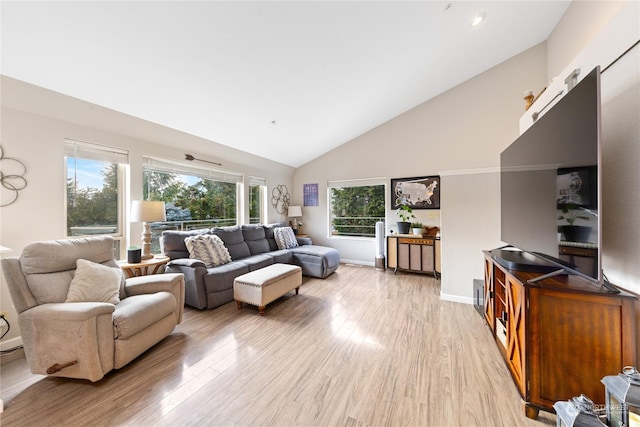 living room with high vaulted ceiling and light wood-type flooring