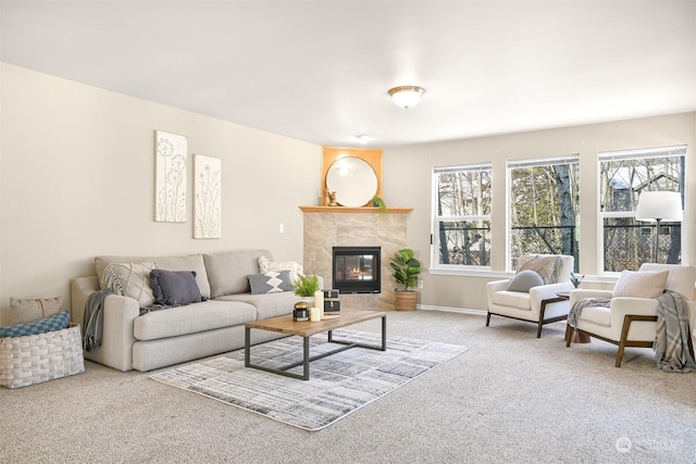 living room with a tile fireplace and light carpet