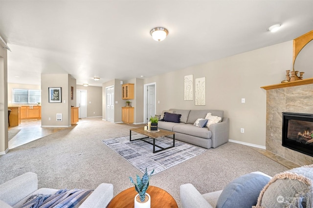 carpeted living room featuring a fireplace