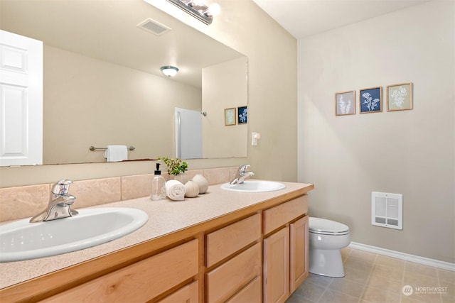 bathroom with tile patterned flooring, vanity, and toilet