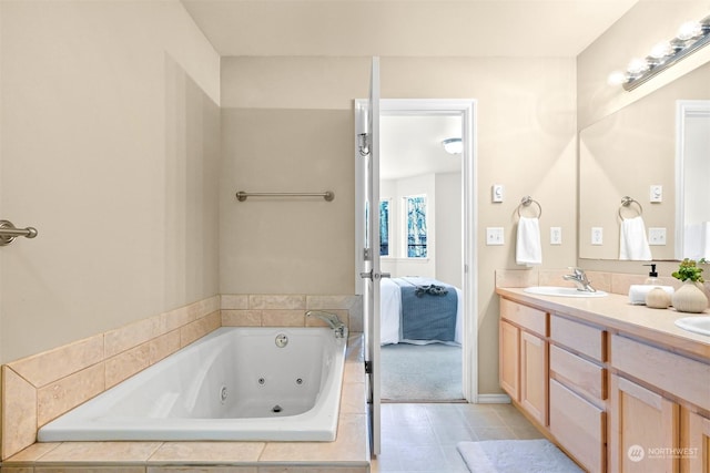 bathroom featuring a relaxing tiled tub and vanity