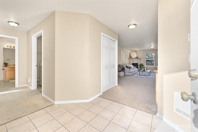 hallway featuring light colored carpet