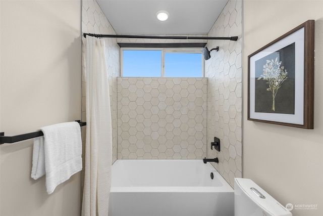 bathroom featuring toilet and shower / bathtub combination with curtain