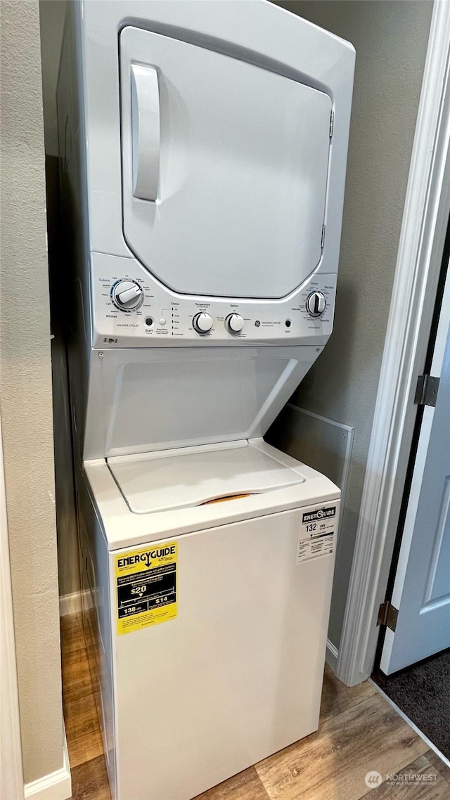 545 Hendricks St Unit 21A, Port Townsend, WA 98368 - washroom featuring light hardwood / wood-style flooring and stacked washer and clothes dryer