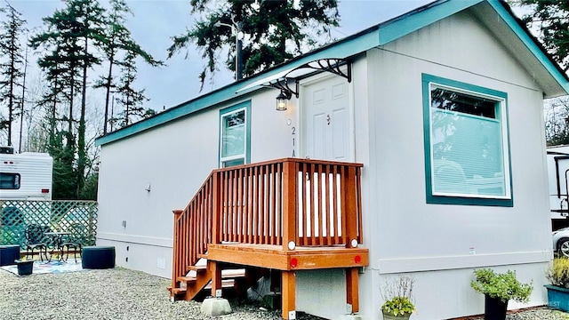 back of house with a wooden deck