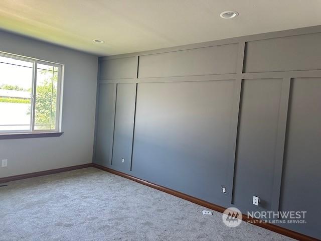 unfurnished bedroom with light carpet and a closet