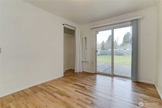 spare room featuring light wood-type flooring