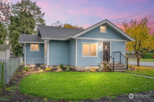 bungalow featuring a yard