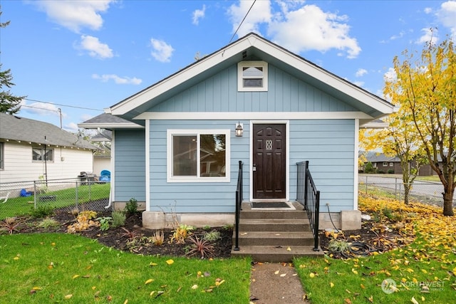 bungalow-style home with a front yard