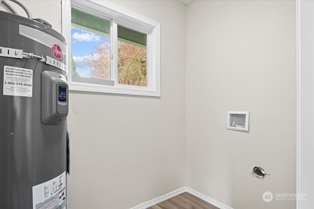 laundry area featuring wood-type flooring and electric water heater