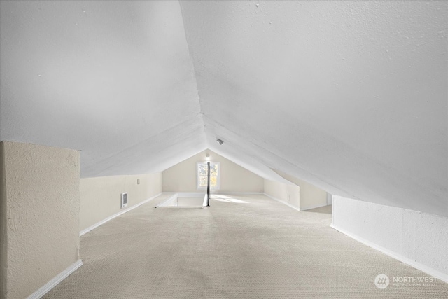 additional living space with lofted ceiling and light carpet