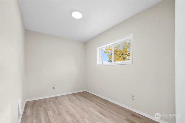 spare room featuring light hardwood / wood-style flooring