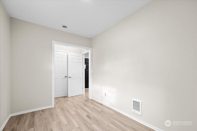 empty room with light hardwood / wood-style flooring