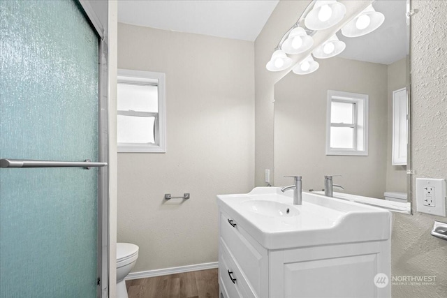 bathroom with hardwood / wood-style flooring, vanity, and toilet