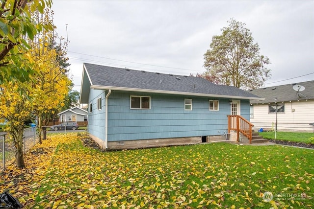 rear view of house with a lawn