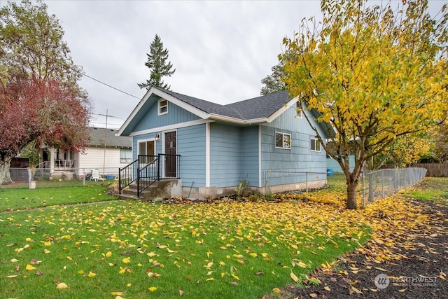 rear view of house featuring a lawn