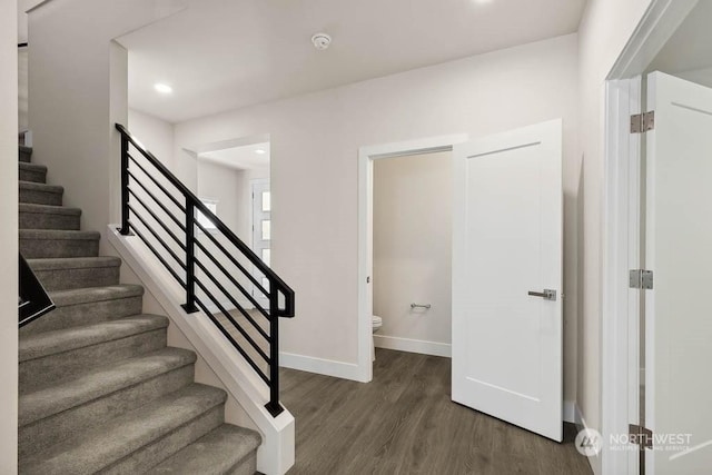 staircase with hardwood / wood-style flooring