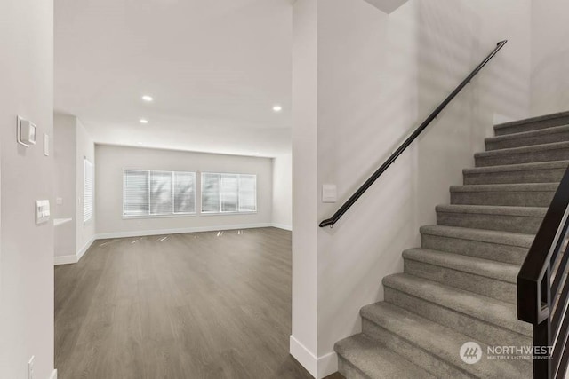 stairs featuring hardwood / wood-style floors