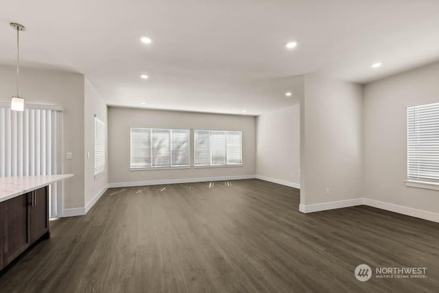 unfurnished living room featuring dark hardwood / wood-style floors