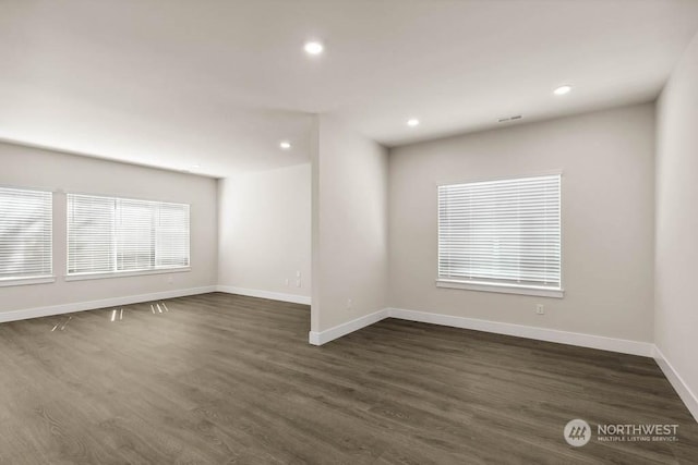 unfurnished room with dark wood-type flooring